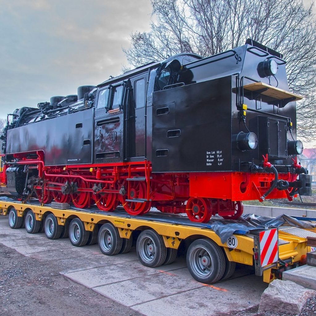 Zug wird auf einen LKW verladen – UBHH Schwerlasttransportlösungen